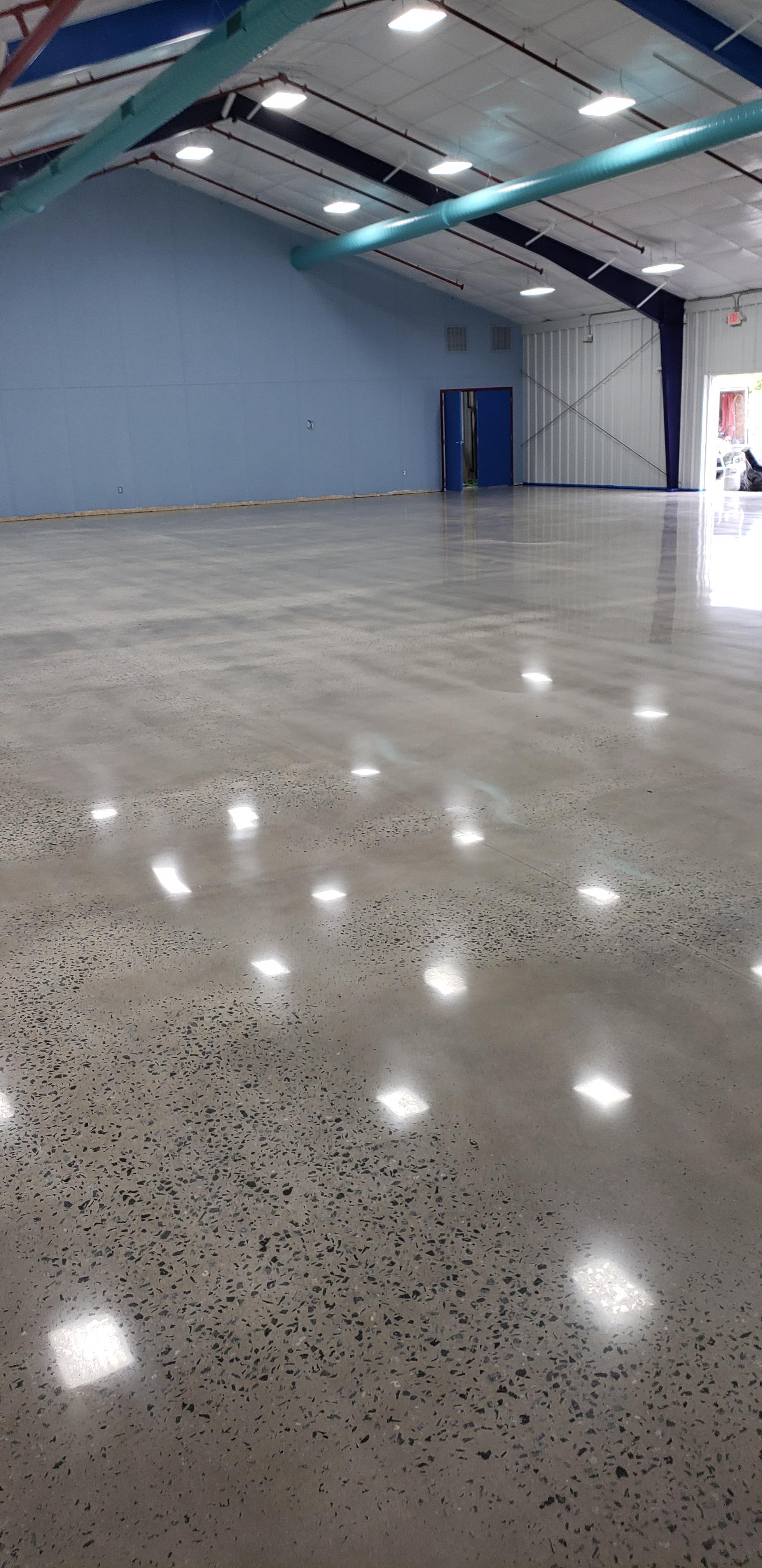 A gray polished concrete floor in an indoor archary range.